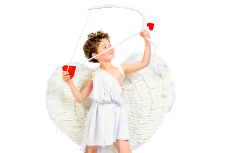 Lovely emotional little boy in a costume of angel. Cupid with a bow and arrows of love. Valentine's day. Isolated over white.の写真素材