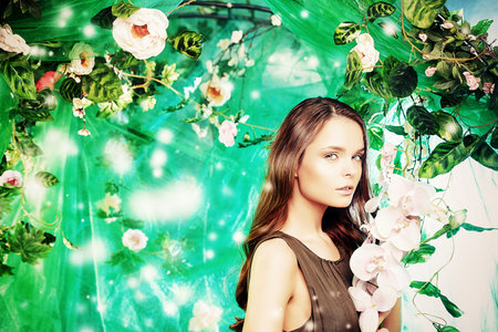 Beautiful young woman  among tropical plants and flowers. Beauty, fashion. Spa, healthcare.の写真素材
