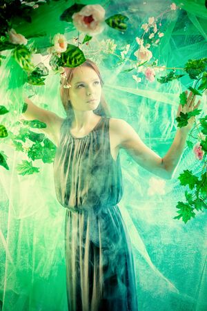 Beautiful young woman  among tropical plants and flowers. Beauty, fashion. Spa, healthcare.の写真素材