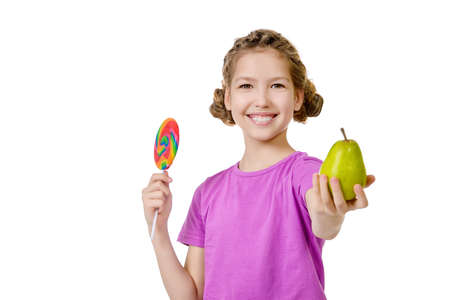 Smiling teen girl making right choice of healthy nutrition. Studio shot. Isolated over white.の写真素材
