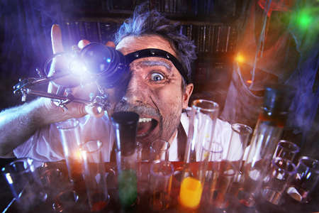 Portrait of a crazy medieval scientist working in his laboratory. Alchemist. Halloween.の写真素材