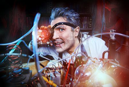Portrait of a crazy medieval scientist working in his laboratory. Alchemist. Halloween.の写真素材