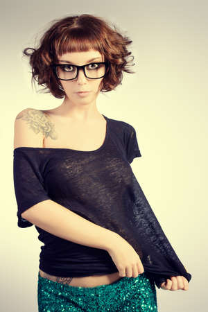 Attractive girl in spectacles alluring in sexual clothes. Beauty, fashion.の写真素材
