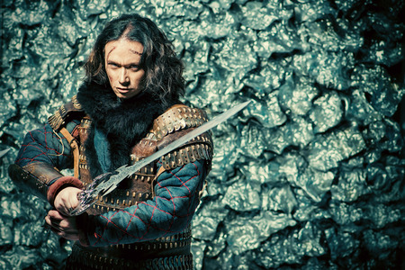 Ancient male warrior in armor holding sword. Historical character. Fantasy.の写真素材