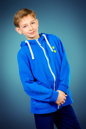 Portrait of a smiling teen boy in casual sportswear. Studio shot.の写真素材