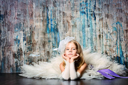 Art portrait of a pretty little girl wearing princess dress. Fashion shot. Childhood.の写真素材