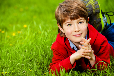 Cute 7 years old boy having fun outdoor. Summer day.の写真素材