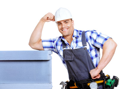 Male construction worker in working clothes, helmet and tools. Isolated over white.