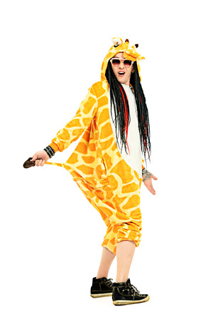 Rock musician in a costume of giraffe dancing and singing at studio. Zoo party. Entertainment, rock show. Isolated over white.の写真素材