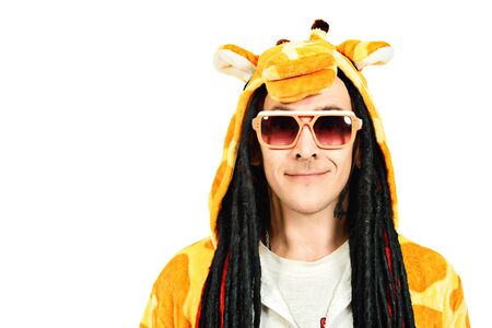 Rock musician in a costume of giraffe dancing and singing at studio. Zoo party. Entertainment, rock show. Isolated over white.の写真素材