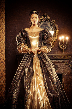 Renaissance Style -  beautiful young woman in the lush expensive dress in an old palace interior. Vintage style. Fashion.の写真素材