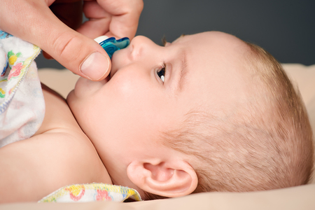Angelic little baby lying in his bed. Healthcare. Happy childhood.の写真素材