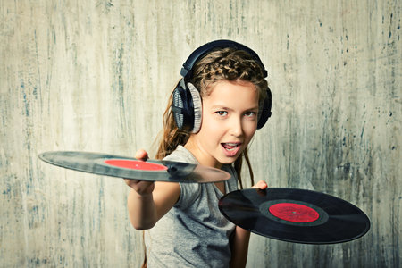 Cute happy teen girl enjoys the music in headphones. Generation. Studio shot.の写真素材