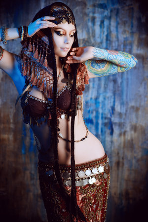 Art portrait of a beautiful traditional female dancer. Ethnic dance. Belly dancing. Tribal dancing.の写真素材