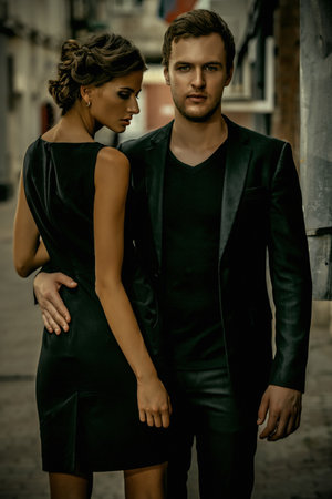Fashion style photo of a beautiful couple over city background.の写真素材