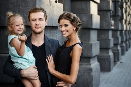 Modern young family walking in the city. Fashion shot.の写真素材