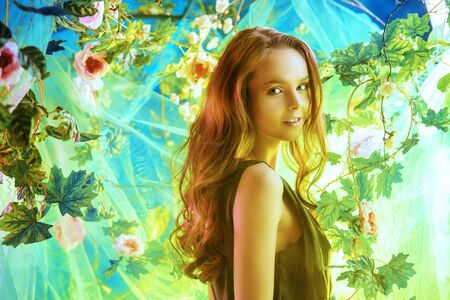 Beautiful young woman  among tropical plants and flowers. Beauty, fashion. Spa, healthcare.の写真素材