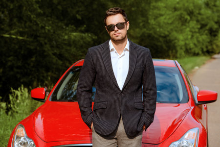Handsome young man in his new sports car.