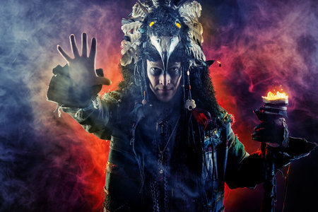 Portrait of a male shaman in ethnic dress surrounded by fogの写真素材