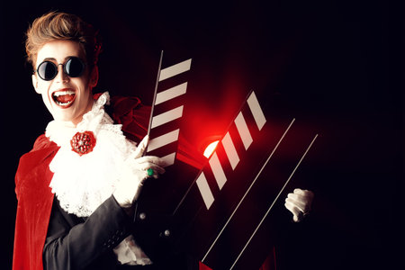 Portrait of a extravagant vampire with a clapper board