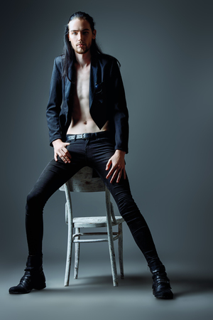 Vogue style photo of a handsome man in black clothesの写真素材