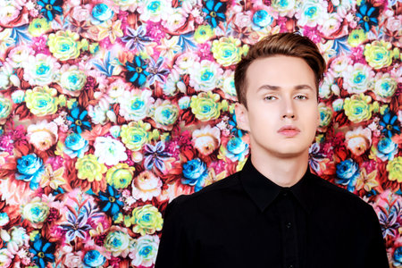 Beautiful young man over floral background
