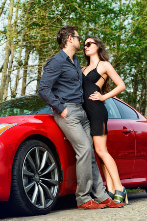 Beautiful couple near the car. Beauty, fashion. Love concept.の写真素材