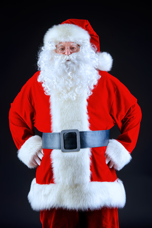Close-up portrait of Santa Claus over black background. Christmas time.の写真素材