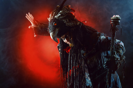 Portrait of a male shaman in ethnic dress surrounded by fog. Fantasy concept, magic.の写真素材