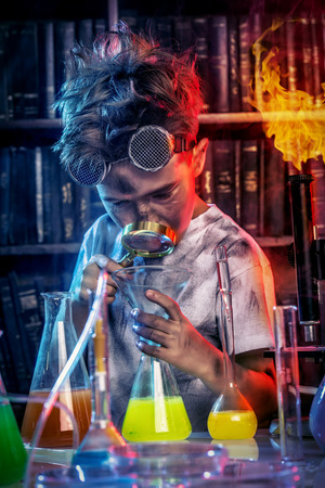 A boy doing experiments in the laboratory. Explosion in the laboratory. Science and education.の写真素材