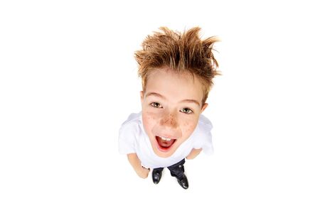 A boy in white t-shirt stares into the camera, he is surprised. Isolated over white background.の写真素材