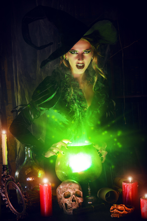 Attractive witch conjures in the wizarding lair. Fairytales. Halloween.の写真素材