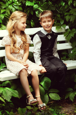 Romantic children at a park. Retro style.の写真素材