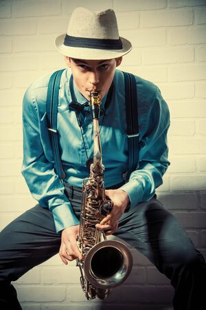 Young expressive musician playing the saxophone. Art and music. Jazz music.の写真素材