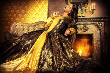 Renaissance Style -  beautiful young woman in the lush expensive dress in an old palace interior. Vintage style. Fashion.の写真素材