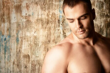 Portrait of a handsome muscular man over grunge background.の写真素材