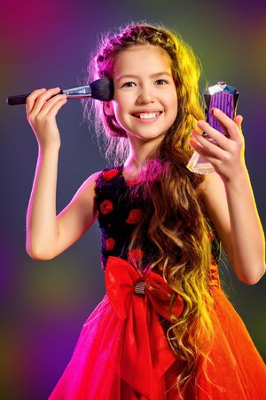 Cute teen girl in a beautiful festive dress going to the party.の写真素材