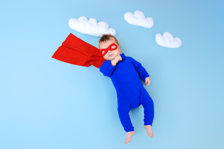 Newborn baby. Little super hero flying through the sky.の写真素材