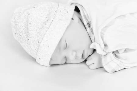 Sweet little newborn baby sleeping in her bed.の写真素材