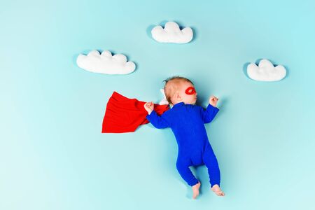 Newborn baby. Little super hero flying through the sky.の写真素材