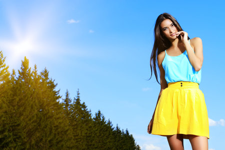 Happy smiling girl standing outdoor. Summer day.の写真素材