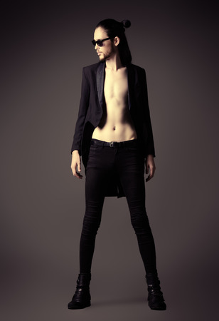 Vogue style photo of a handsome man in black clothes. Men's fashion, beauty.の写真素材