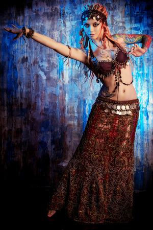 Art portrait of a beautiful traditional female dancer. Ethnic dance. Belly dancing. Tribal dancing.の写真素材