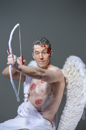 Male angel Cupid with a bow and arrows of love. Valentine's day. Love concept.の写真素材