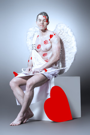 Male angel Cupid with a bow and arrows of love. Valentine's day. Love concept.