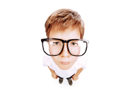 Serious smart boy wearing big glasses staring at the camera. Education. Studio shot. Isolated over...