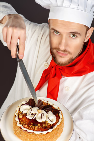 Portrait of a male confectioner cooking a delicious cake.の写真素材