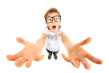 Funny boy in big glasses stretches his hands to the camera. Education. Isolated over white.
