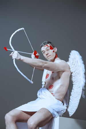 Male angel Cupid with a bow and arrows of love. Valentine's day. Love concept.の写真素材