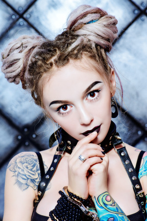 Close-up portrait of the attractive young woman alluring in sexy lingerie over grunge background. BDSM.の写真素材